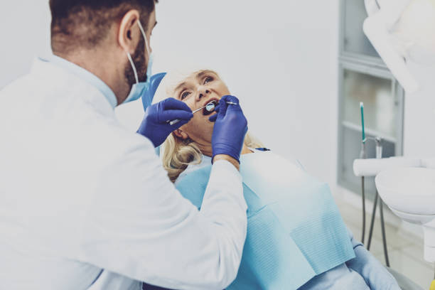 istock Concentrated stomatologist examining his visitor 980263518