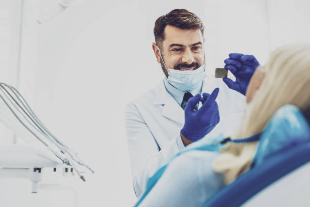 istock Pleased stomatologist pointing at X-ray picture 980265874