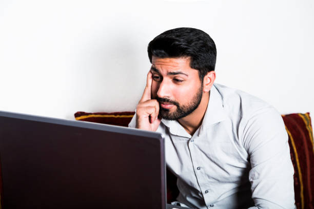 istock Man sitting in casual clothes working on computer. 980269142