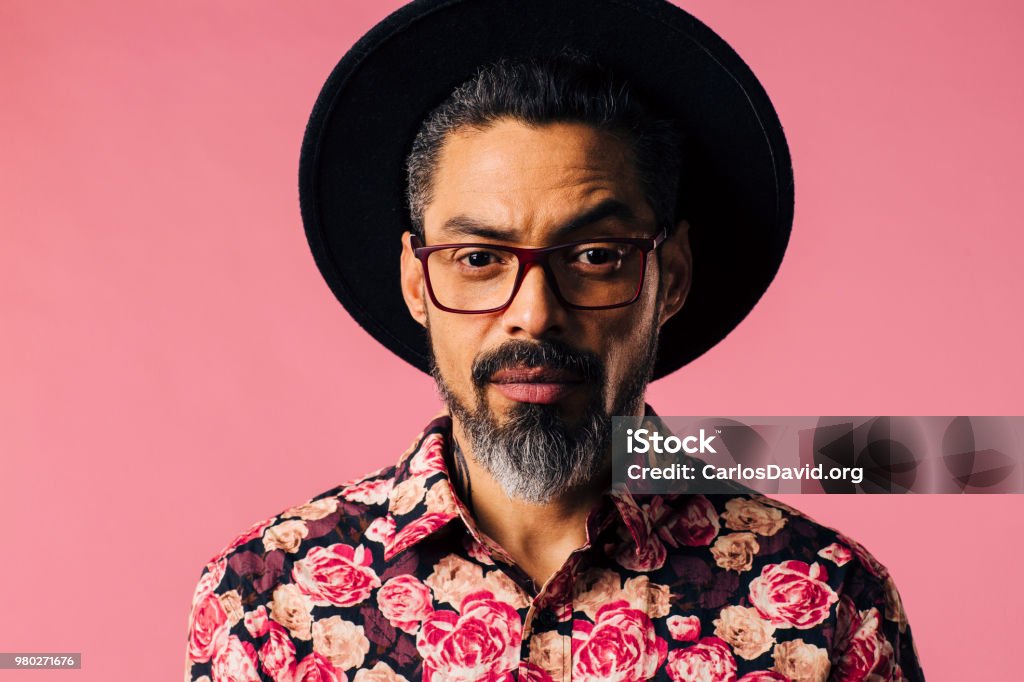 Portrait of a mature artist with beard, glasses and hat Portrait of a man with beard, hat  and glasses, isolated in a studio background Men Stock Photo