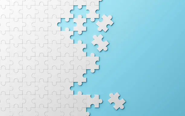 Photo of Jigsaw puzzle, pattern texture separated on blue background. 3d illustration