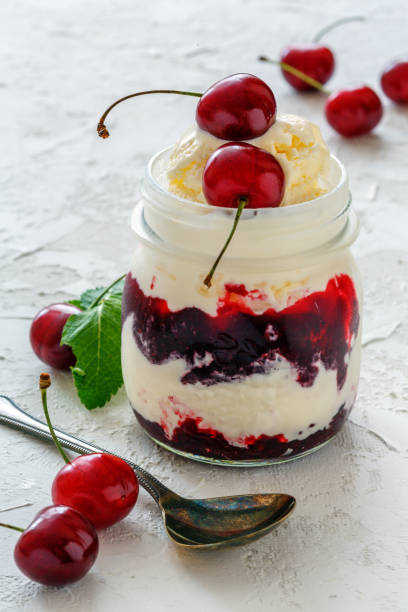 istock Sundae with sweet cherry in a glass jar. 980276370