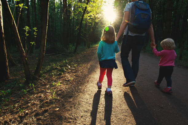istock mother awith kids walking in sunset nature 980288678