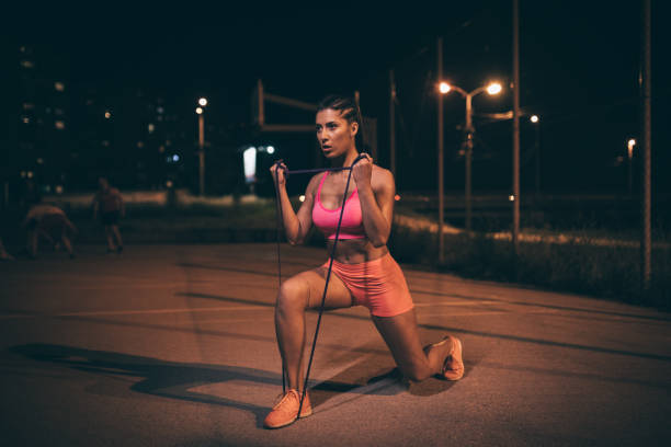 istock Sporty woman exercising outdoors at night 980296318