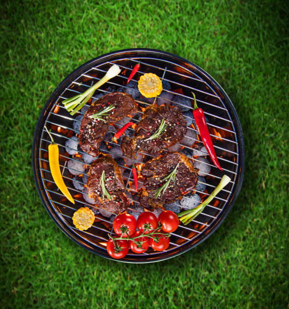 istock Barbecue grill with beef steaks, close-up 980297090