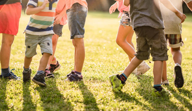 istock Group of unrecognizable kids playing in park 980304612