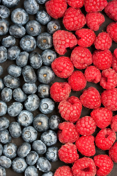 istock Blueberries and raspberries. Food background 980307438