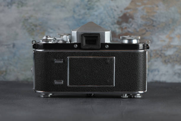istock The old 35 mm SLR camera on a grey cement wall. 980307876