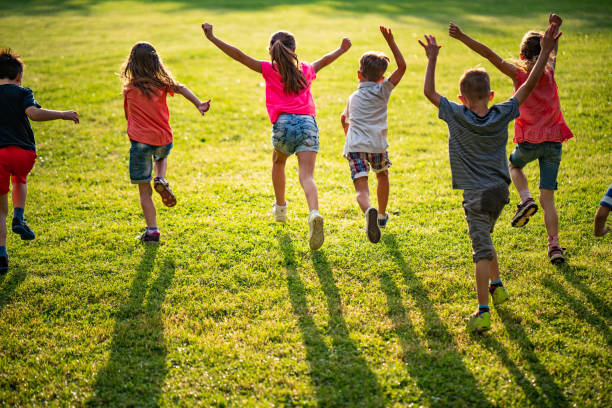 istock Group of kids running in nature 980310490