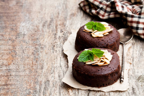 istock Chocolate  fondant with almonds on wooden table 980313214