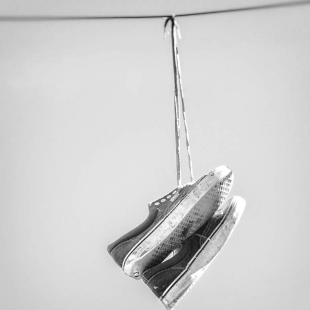 istock Hanging Shoes on Wire 980313282