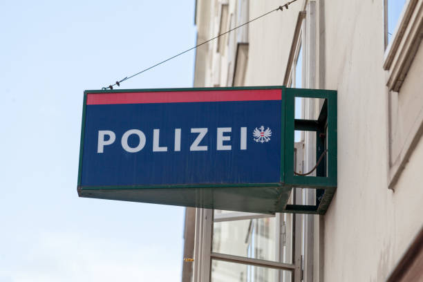 Vienna, Austria - June 18 2018: Red and blue police sign atop the entrance of a police station in Vienna with written \