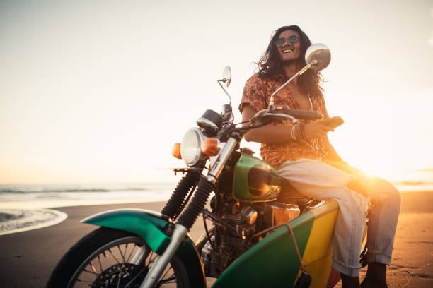 istock Young surfer on a motorcycle at the beach 980314236