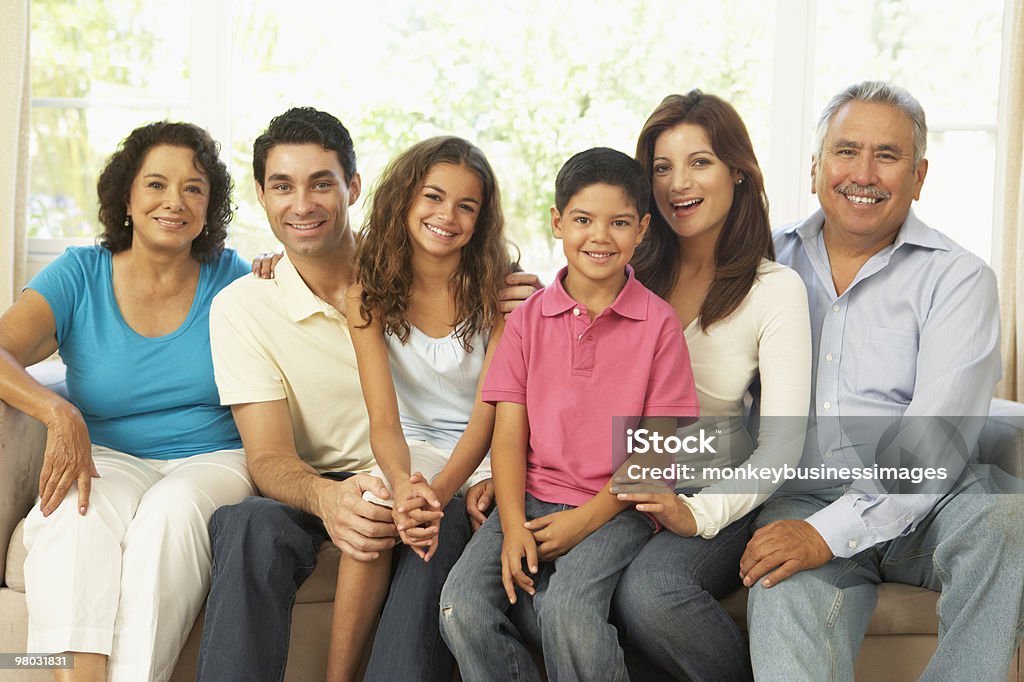 Extended Family Relaxing At Home  Multi-Generation Family Stock Photo