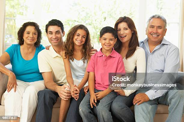 Extended Family Relaxing At Home Stock Photo - Download Image Now - Multi-Generation Family, Family, Latin American and Hispanic Ethnicity