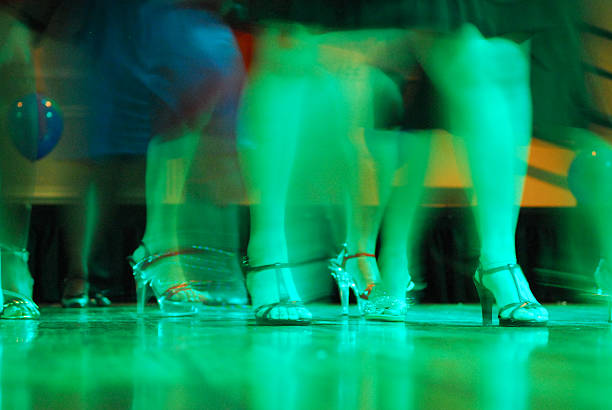 Legs of dancing people at the party.