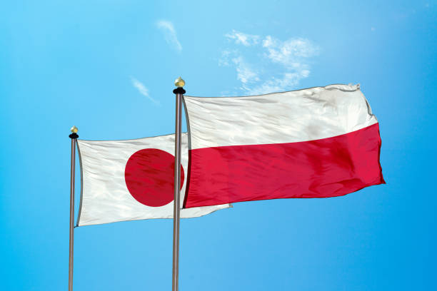 istock Japan vs Poland flag on the mast 980325890