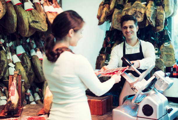 istock Female customer buying Spanish jamon 980349364