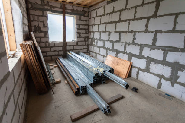 istock Working process of installing metal frames for plasterboard drywall for making gypsum walls in apartment is under construction, remodeling, renovation, extension, restoration and reconstruction 980373066