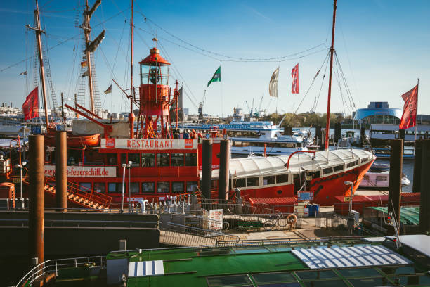 Red fire patrol boat in the port of Hamburg with a restaurant on the board HAMBURG, GERMANY - April 18, 2018: Red fire patrol boat in the port of Hamburg with a restaurant on the board. övelgönne stock pictures, royalty-free photos & images