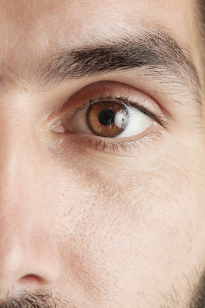 istock Close up view of a brown man eye looking at camera 980381578