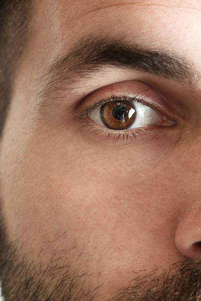 istock Close up view of a brown man eye looking at camera 980382236