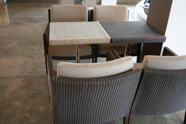 istock Above view of Woven wicker seamless pattern table and chairs on concrete floor. 980400812