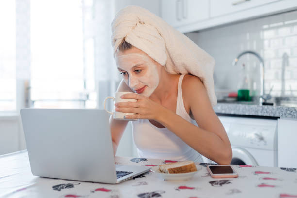 istock Woman with mask using laptop 980400854