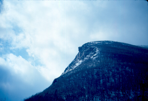 Scan of Slide.  Located in New Hampshire, the Old Man of the Mountain was a state symbol.  Now it has succumbed to ice and water and no longer exists.
