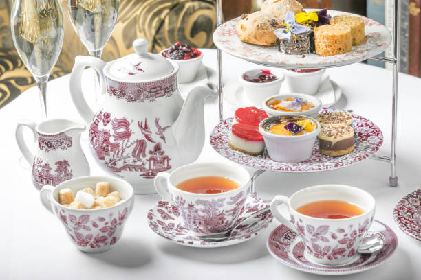 Afternoon high tea old school style tea at five afternoon service sandwich set cake sweet traditional table hotel cheesecake sugar pot blue china cup tea party horizontal nobody indoors stock pictures, royalty-free photos & images