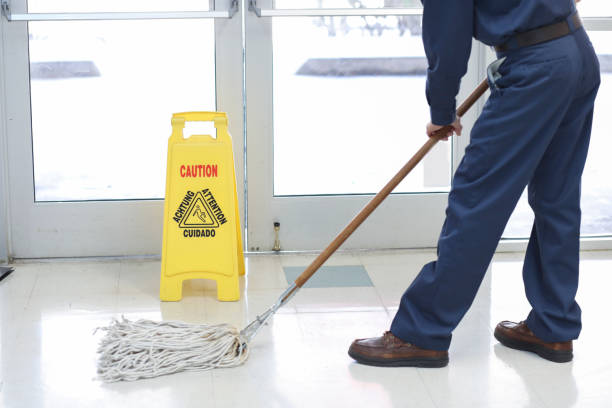 Mature Man Cleaning Floor With Mop Over White Background
