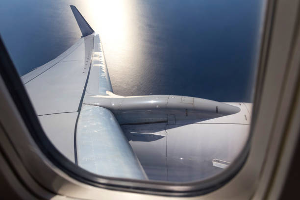 istock view through an airplane window mid air over the sea 980406300