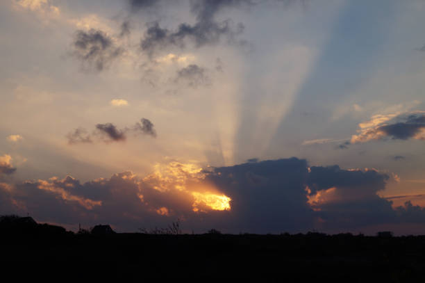 Sunny sunset against a background of low clouds.