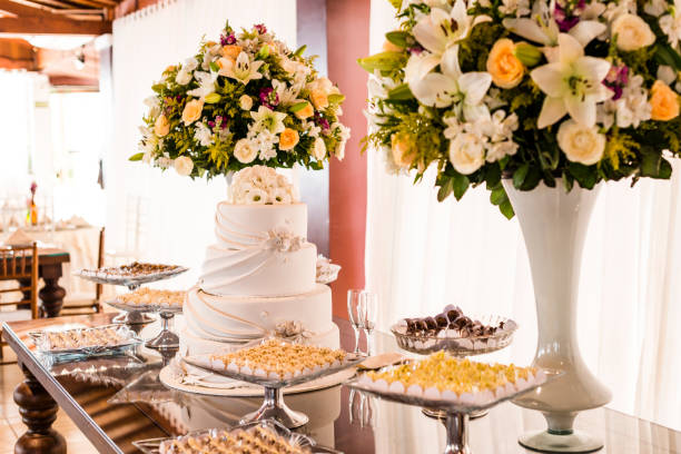 istock Cake table with candies and flower pots - top view 980414648