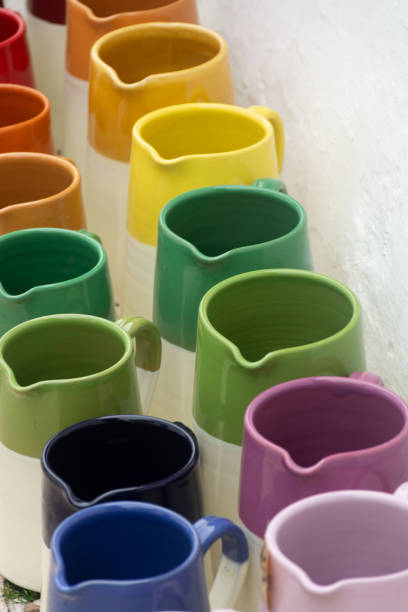 istock Rows with colorful glazed ceramic jars, flower pots, vases for sale 980424886