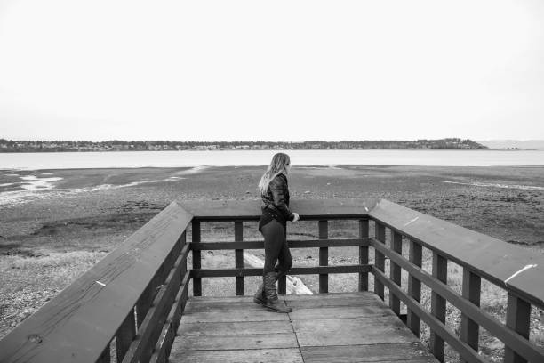 istock Contemplative woman on the dock 980425072