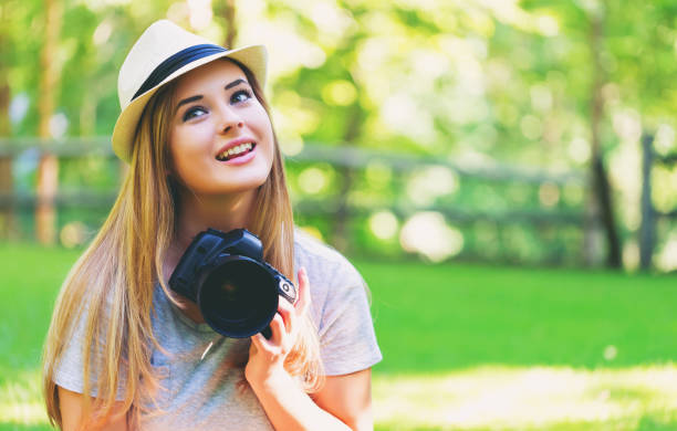 istock Female photographer with a camera outside 980428012