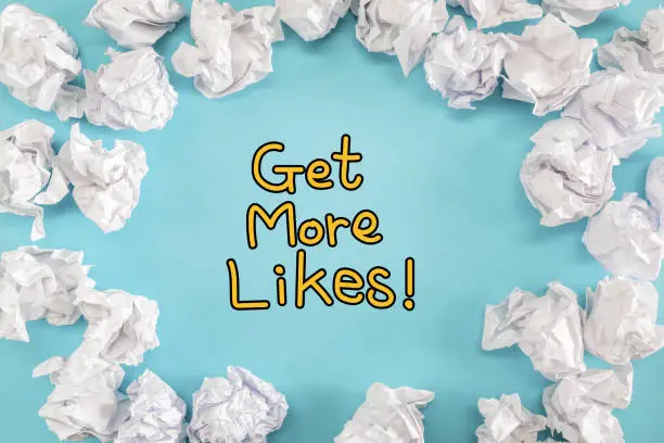 Photo of Get More Likes text with crumpled paper balls