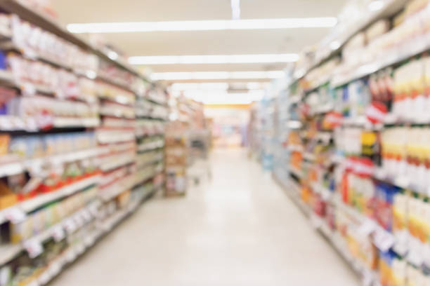istock Empty supermarket aisle with product on shelves blurred background 980433020