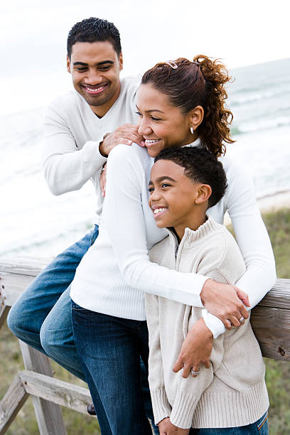 istock African-American family hugging at beach 98044981