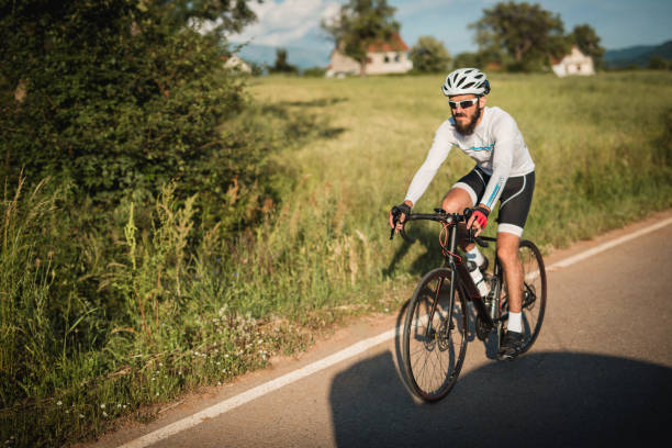 istock Young man road cycling training 980451650
