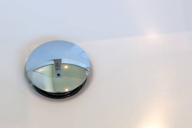 istock Water tap reflecting in sink pop-up drain with copy space 980451948