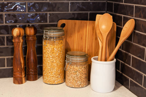 istock Wooden cooking utensils set on modern kitchen cooktop 980455118