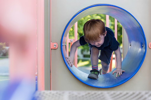 Little Boy Exploring and Playing on Playground in public park