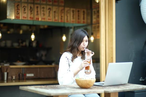 istock Woman working with a laptop at a bar 980458302