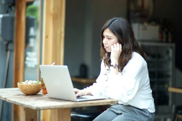 istock Woman working with a laptop at a bar 980458314