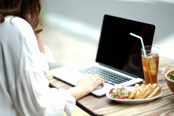 istock Woman working with a laptop at a bar 980458352