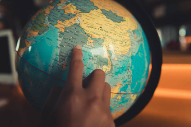 teenagers searching place on a globe