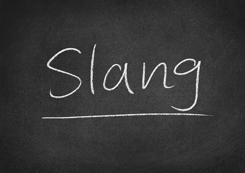 slang concept word on a blackboard background