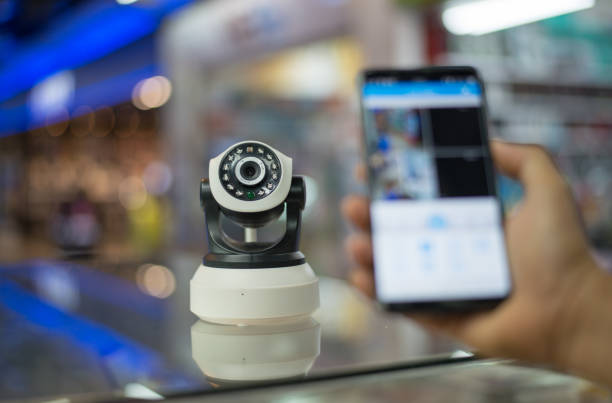 istock Man hand on  press program in the phone to watch CCTV 980499600